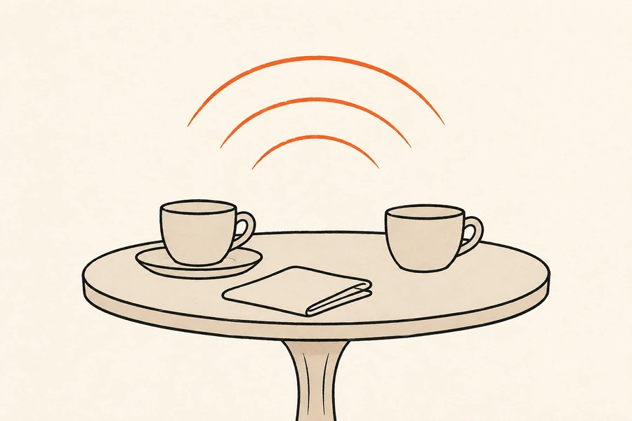 A café table with two cups and a folded newspaper, with orange sound waves rising above it.