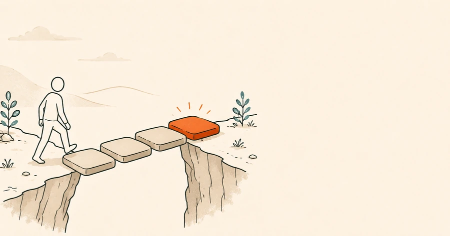 A person stepping across a break in the ground on flat stones towards a glowing orange one.