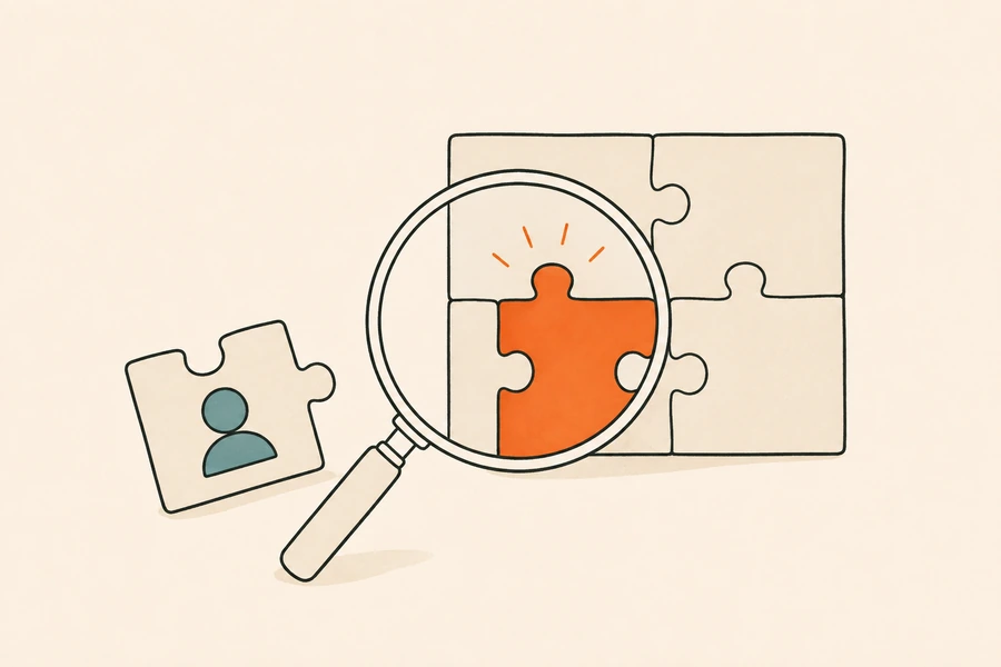 A magnifying glass over a jigsaw, showing the orange piece that completes it, with a loose piece beside it.